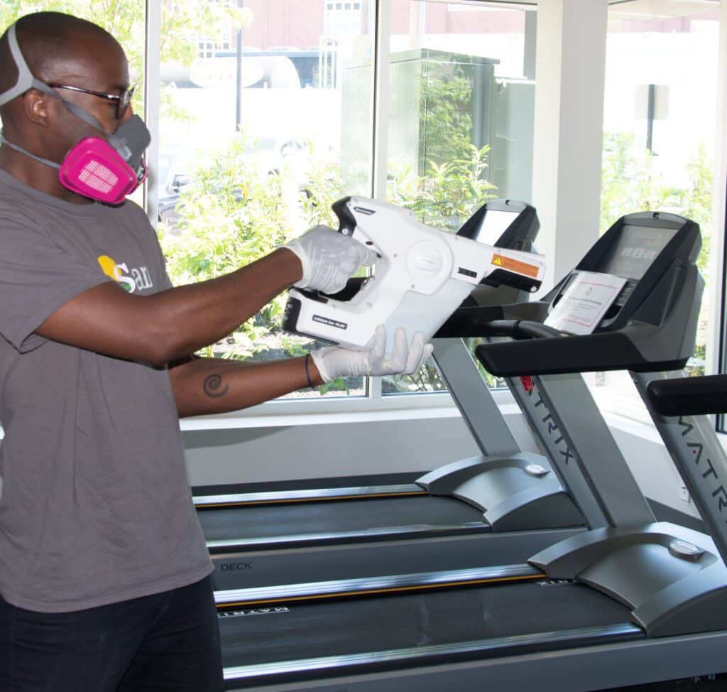 Deep Cleaning services - Staff with electrostatic machine doing cleaning